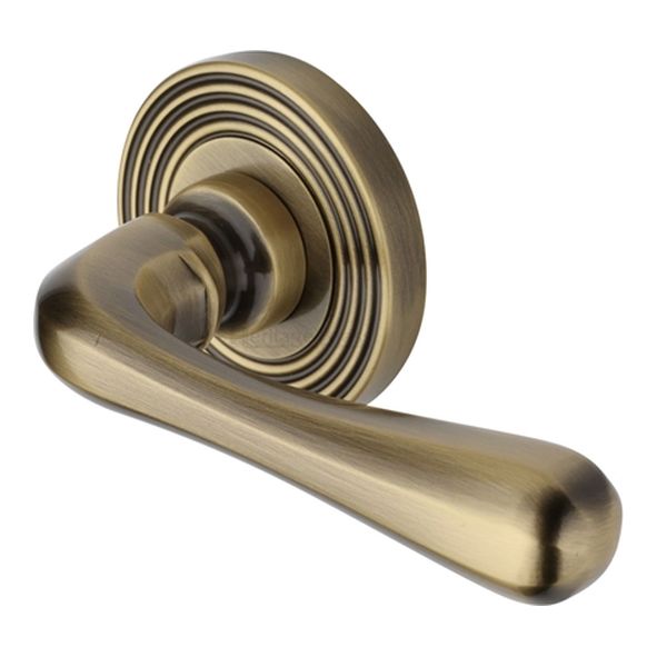 RR3022-AT  Antique Brass  Heritage Brass Charlbury Reeded Lever Furniture on Round Rose